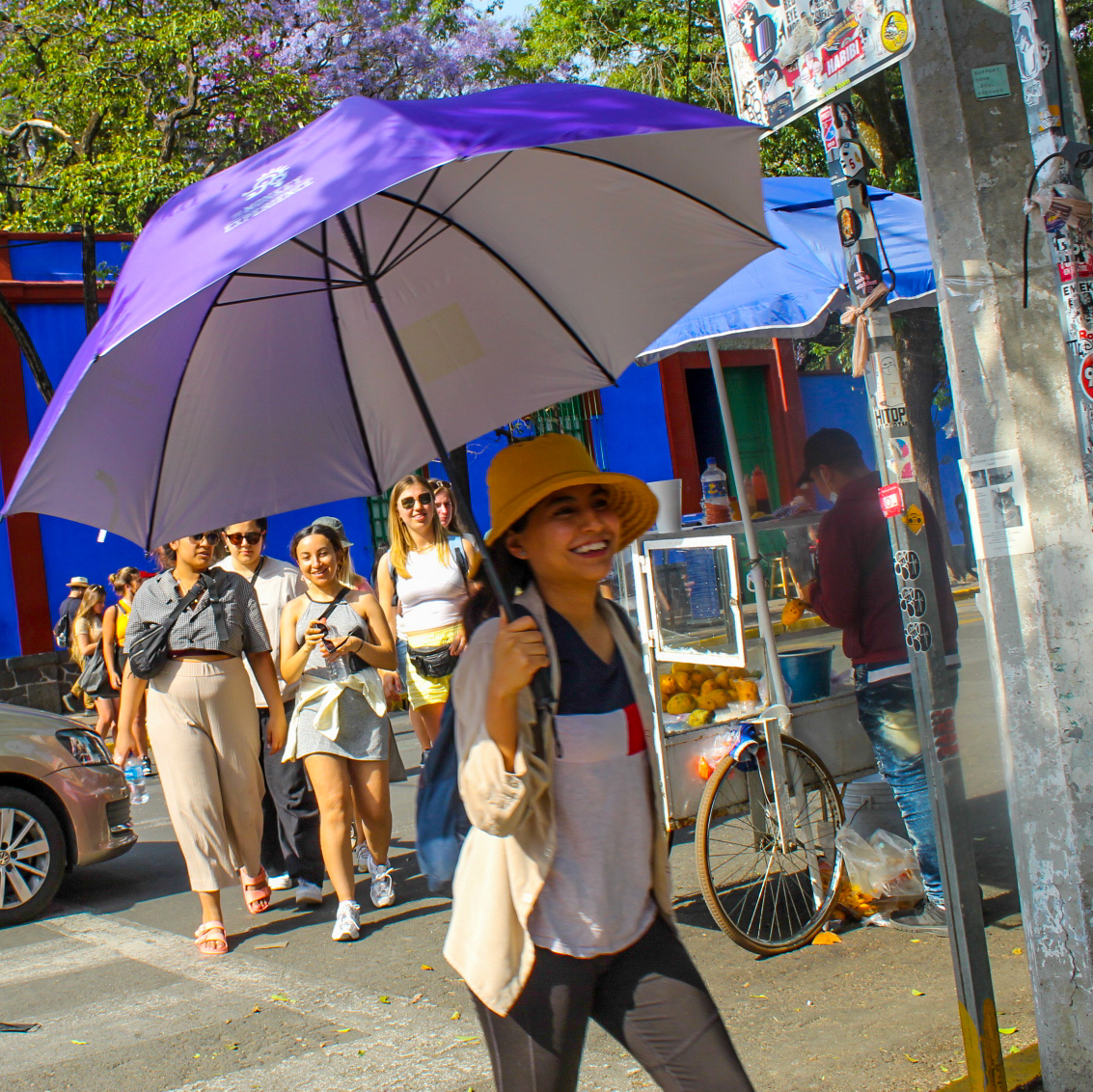 a group of people that are standing in the rain with an umbrella