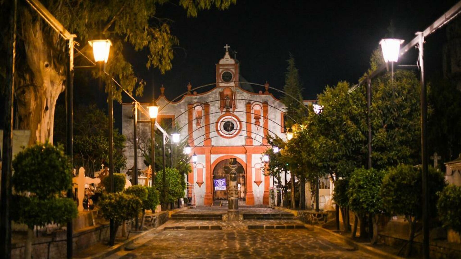 a clock tower in the middle of the street