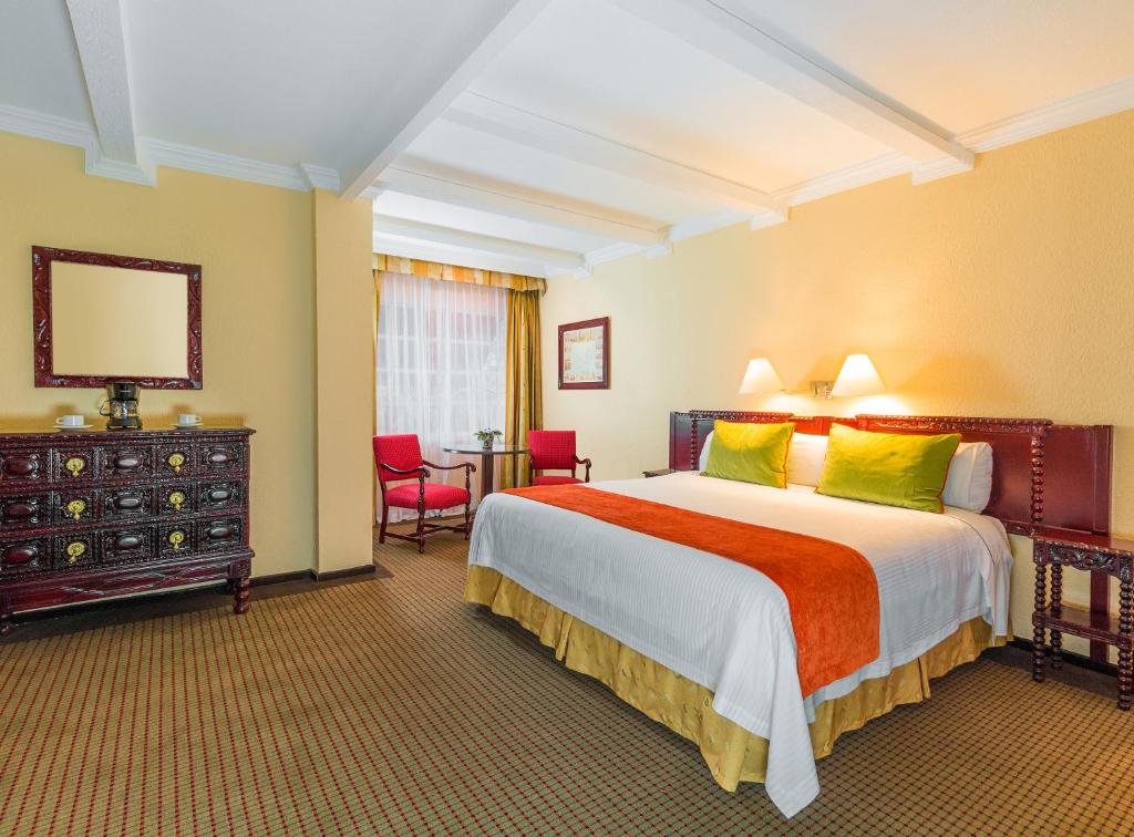 a bedroom with a large bed in a hotel room