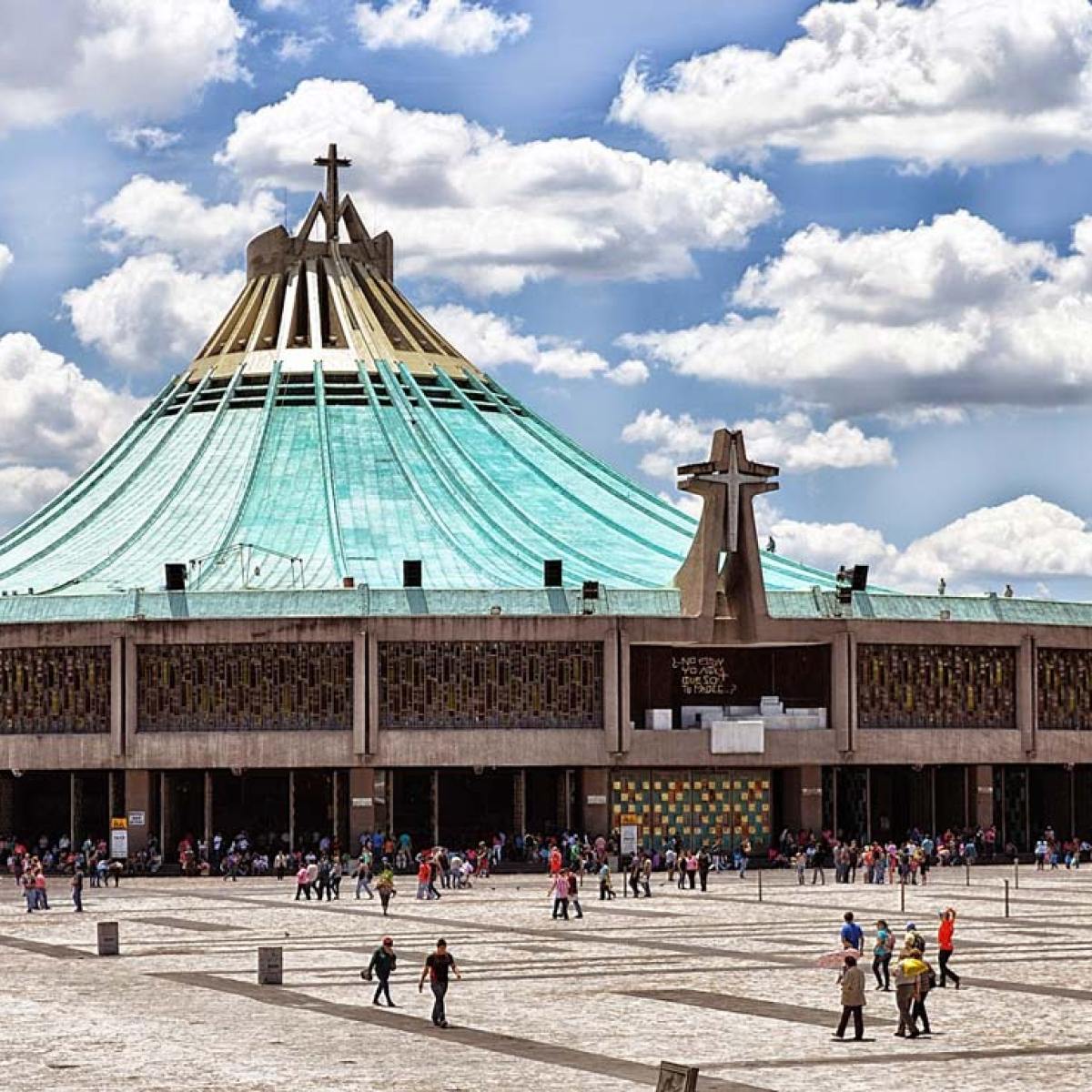 a group of people on a beach in front of Basilica of Our Lady of Guadalupe