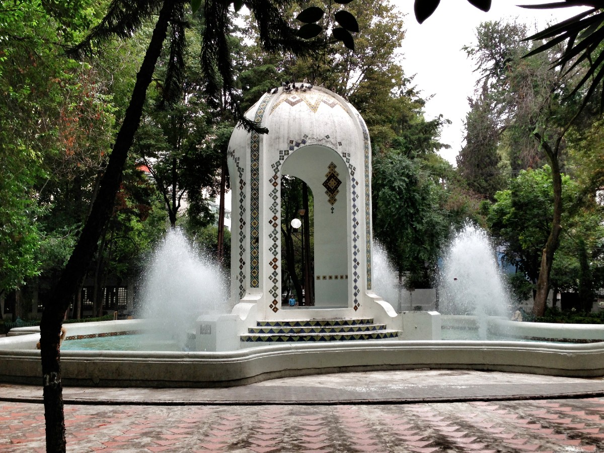 a fountain in front of a fire hydrant