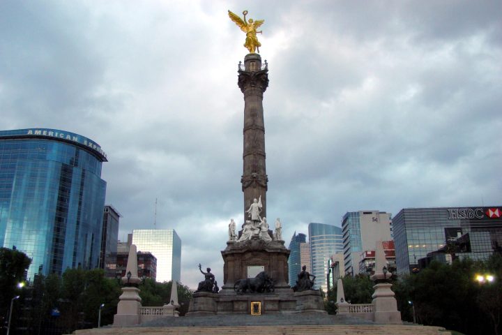 a statue in front of a tall building