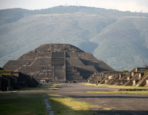 a large body of water with Pyramid of the Sun in the background